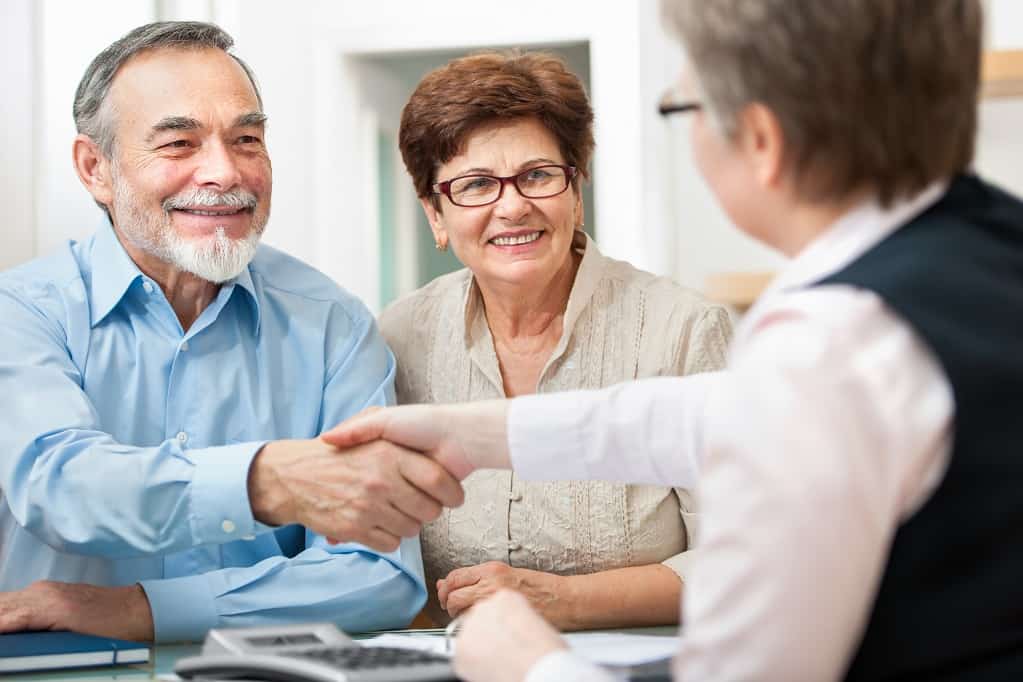 Old man shaking hands to a woman